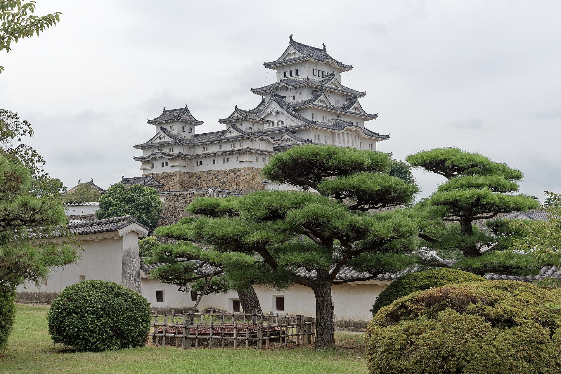 The main keep of Himeji Castle rising brilliant white against a clear summer sky
