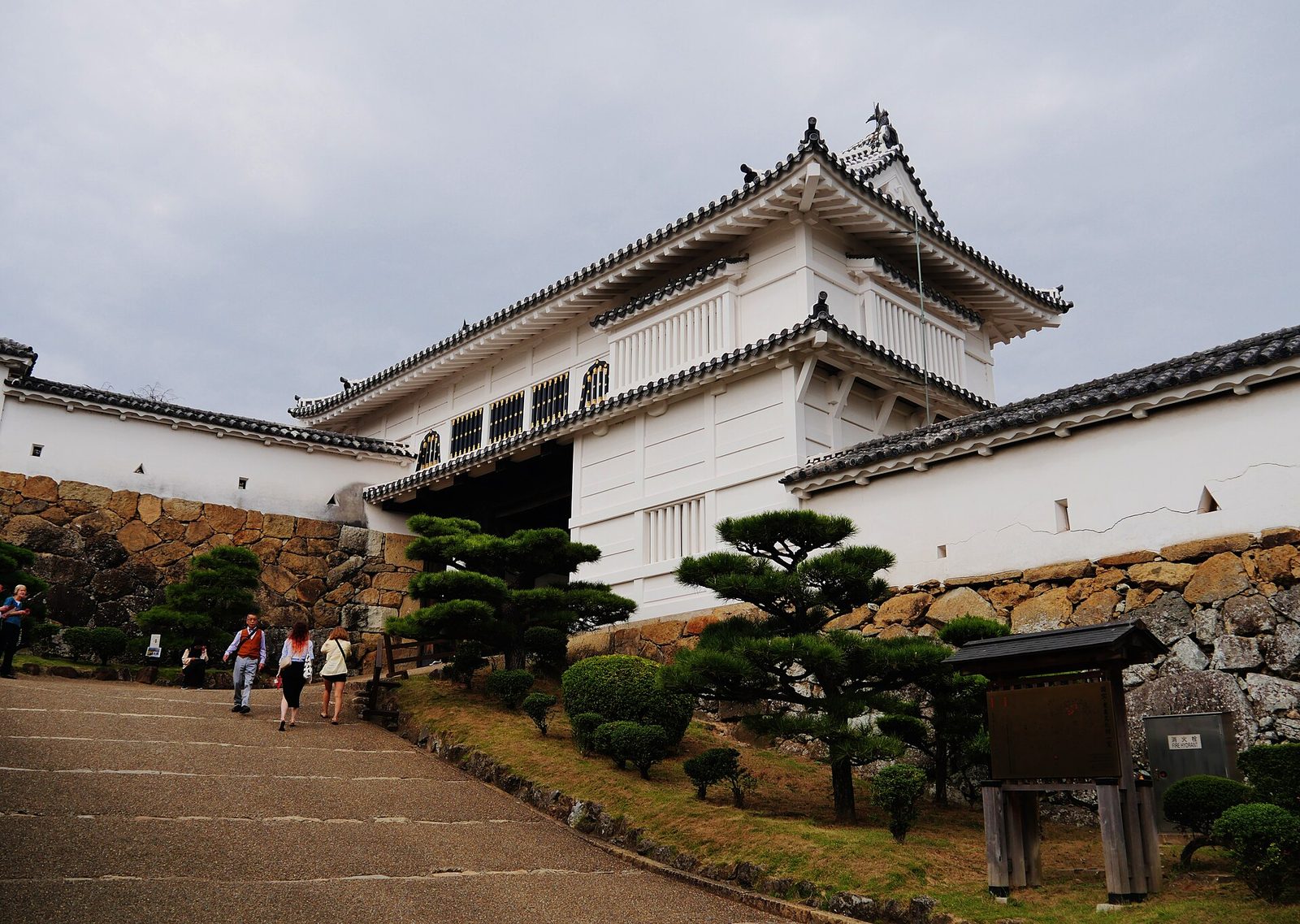 Visitors passing through the timber Hishi Gate of Himeji Castle